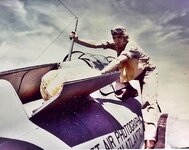 F4F Pilot checks life raft stowage, behind the cockpit. In this quickly releasable hatch, the ...jpg