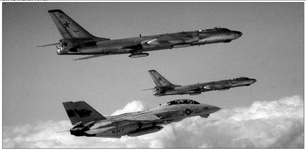 F-14A of VF-1 Wolfpack escorting two Tu-16PP recon bombers over western Pacific mid 1980's TWO...png