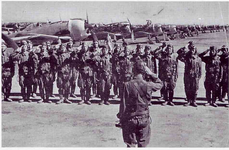 Fighter trainees and their instructor. To the rear is a row of Ki-44 Shoki model 2s..png