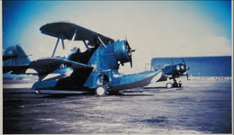 Grumman J2F-5 Duck and Douglas SBD-3P of VJ-14 at NAS Moffet Field, California 1943 BIREDTODU.png