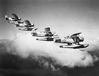 SOC-3 scout-observation floatplanes off cruiser USS Honolulu flying in formation, circa 1938-1...png