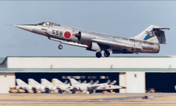 In the background of this photo, you can see a line of T2 fighter jets from the Aggressor Forc...png