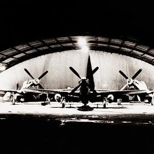 P-51 Mustangs in english Quonset hangar
