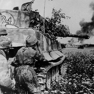 German Paratroopers behind a Tiger I tank in combat.