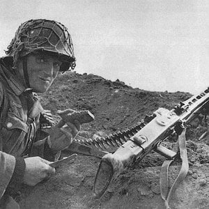German Army MG42 machine gunner takes a pause to have a lunch