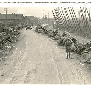 A German Soldier Beside Smashed Allied Equipment.