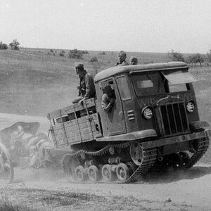 A captured by Germans , soviet atillery tractor ( Artillerieschlepper )  CT3-5 (STZ-5) towing a gun