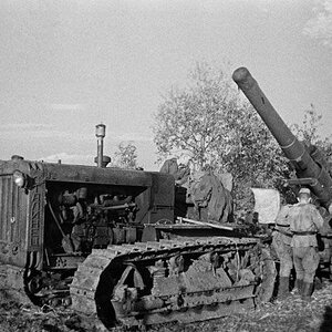 A S-65 Stalinetz tractor towing a heavy gun