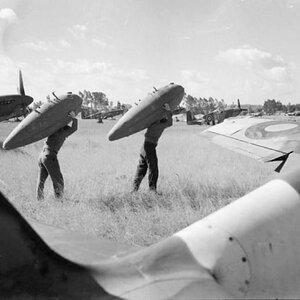 The maintenance crew of the NA Mustang Mk.IIIs of No. 65 Squadron RAF at work ...