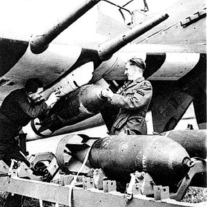 Hawker-Typhoon dive bomber loads 500-lb bombs under 20mm cannon