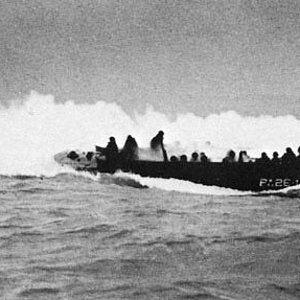 A landing craft hit by artillery on its way to the beaches