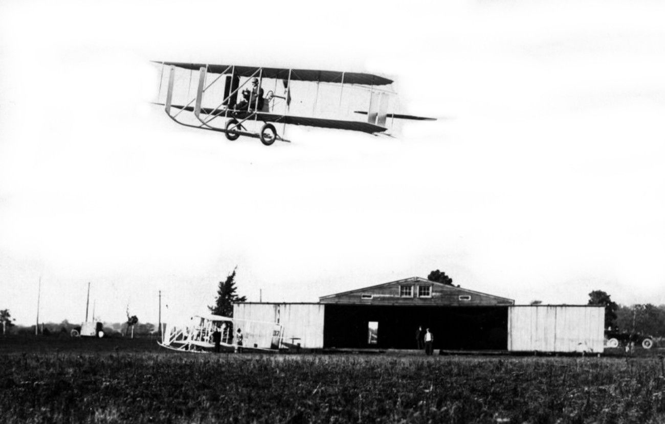 1913_Model_E_over_hangar