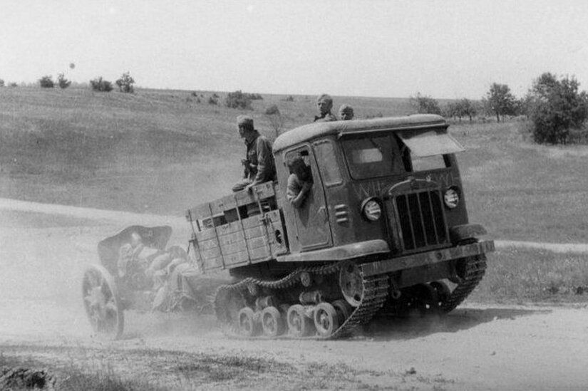 A captured by Germans , soviet atillery tractor ( Artillerieschlepper )  CT3-5 (STZ-5) towing a gun