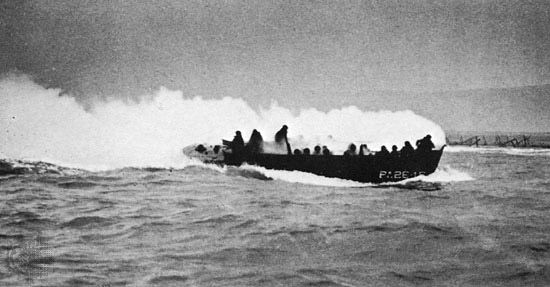 A landing craft hit by artillery on its way to the beaches
