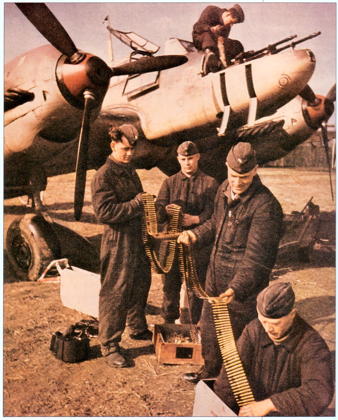 Bf 110 armourers reloading its guns in colour.jpg