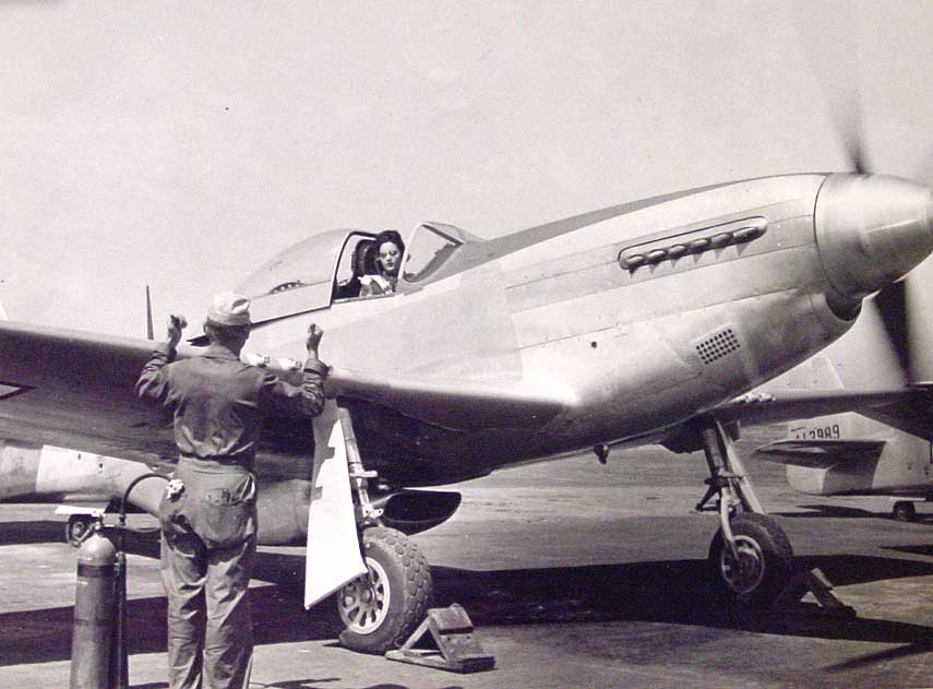 Ferry pilot Florene Watson, WAF, warms up her P-51