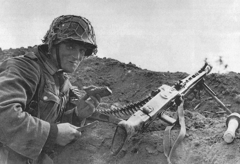 German Army MG42 machine gunner takes a pause to have a lunch