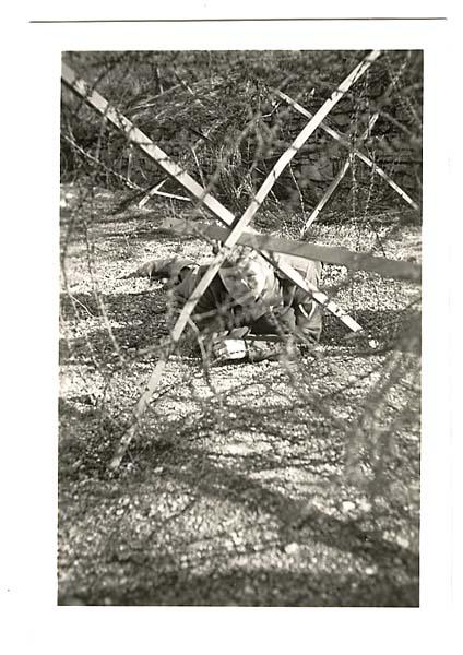 German Soldier Crawling Through Barbed Wire