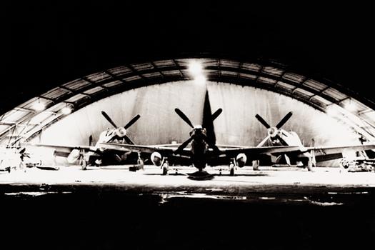 P-51 Mustangs in english Quonset hangar