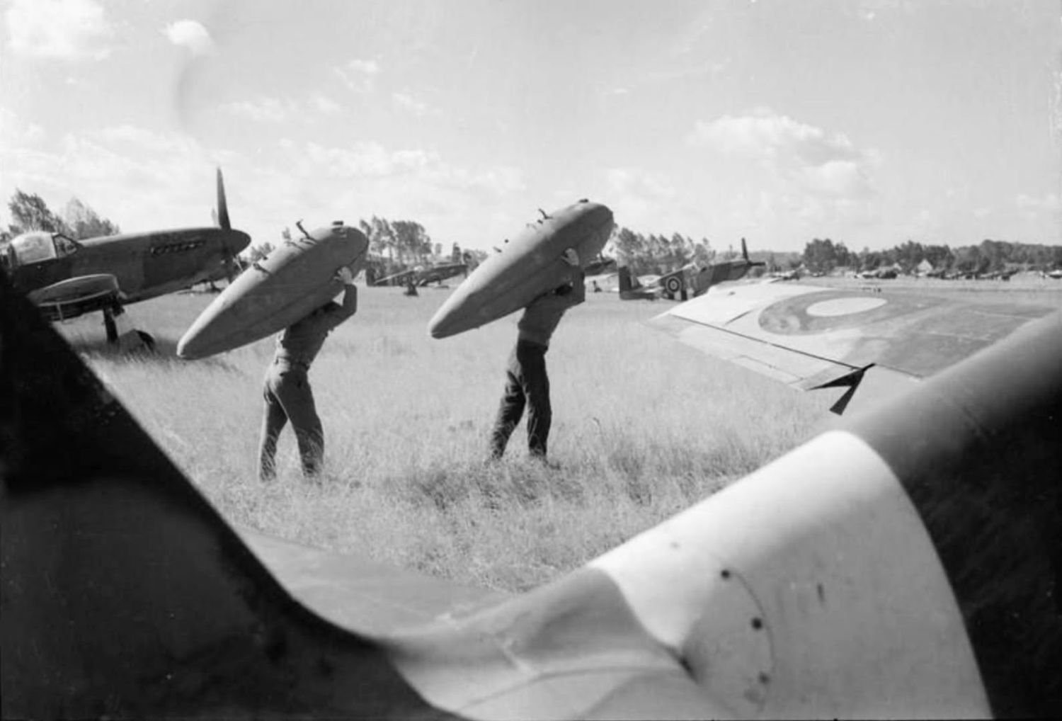 The maintenance crew of the NA Mustang Mk.IIIs of No. 65 Squadron RAF at work ...